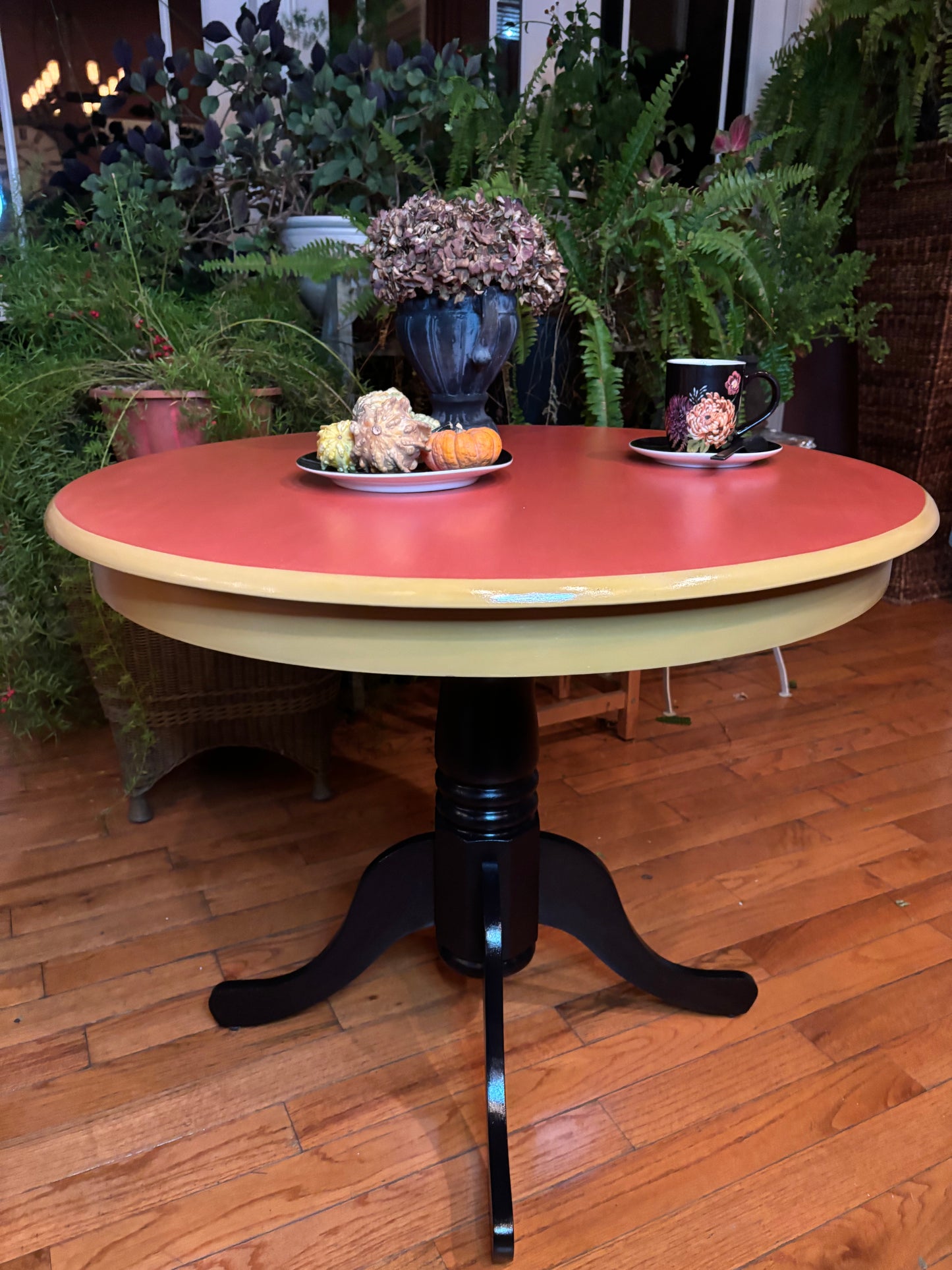 Small Round kitchen table, orange top, yellow beveled area and black legs front