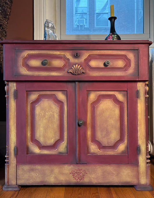 Small vintage cabinet in  Burgundy Chalk Paint, dry brushing in Yellow and some shades of Graphite.