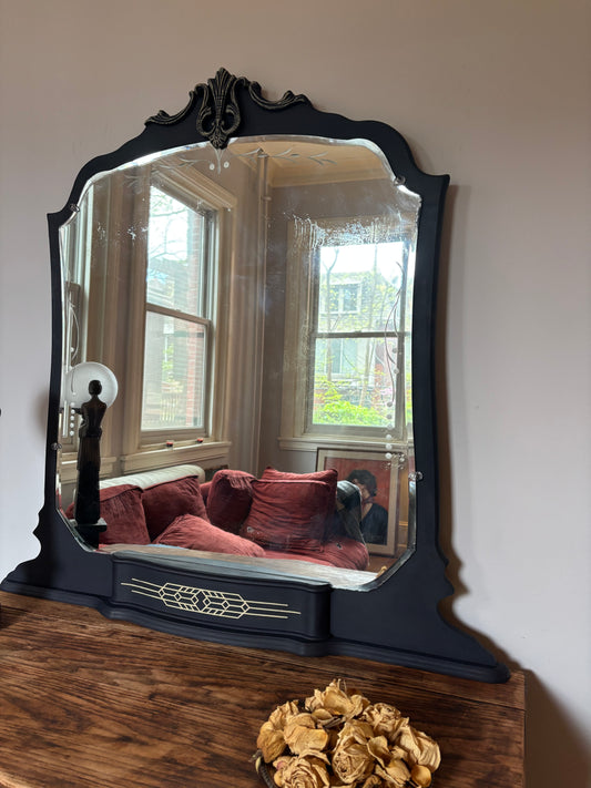 A one-of-a-kind Art Deco mirror featuring an original etched beveled mirror, rich midnight blue finish, and hand-burnished silver accents that capture the timeless glamour of the Jazz Age