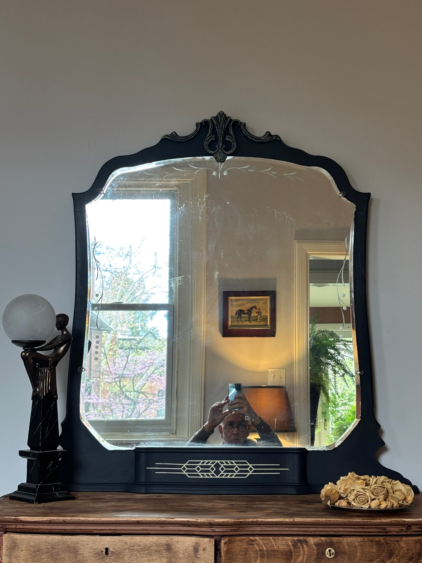 A one-of-a-kind Art Deco mirror featuring an original etched beveled mirror, rich midnight blue finish, and hand-burnished silver accents that capture the timeless glamour of the Jazz Age
