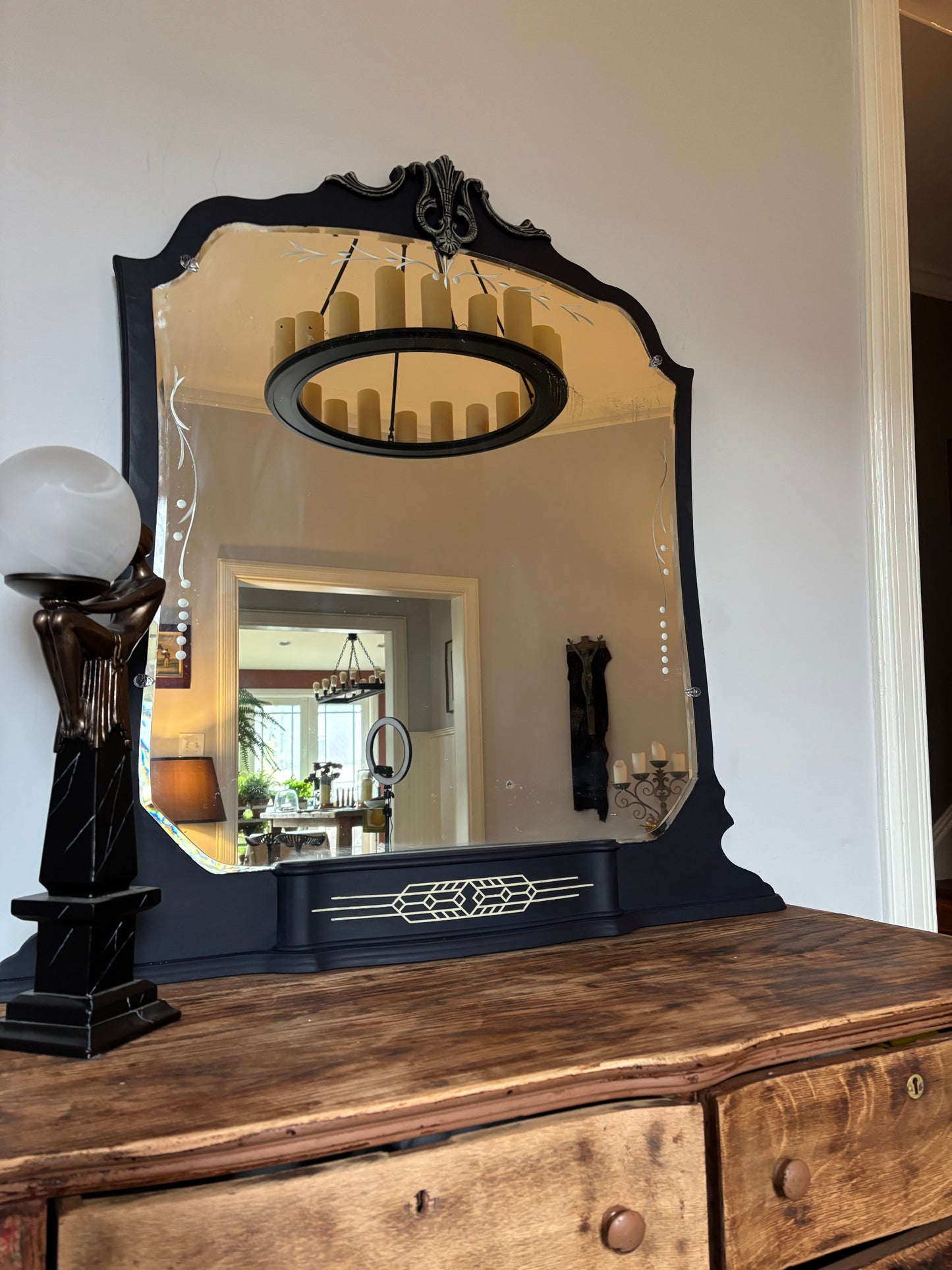 A one-of-a-kind Art Deco mirror featuring an original etched beveled mirror, rich midnight blue finish, and hand-burnished silver accents that capture the timeless glamour of the Jazz Age