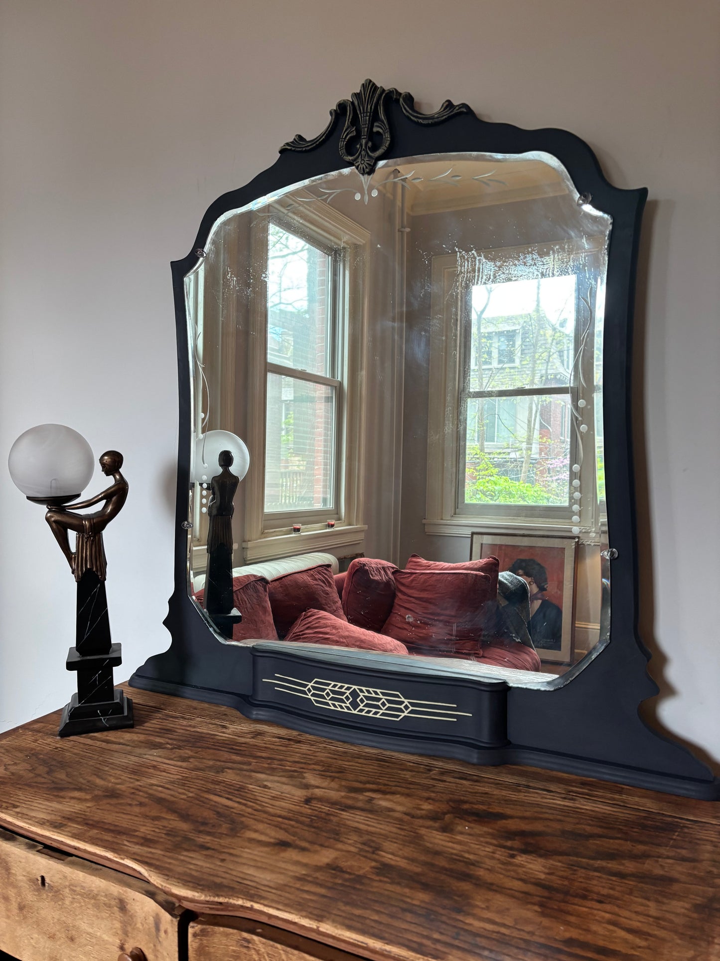 A one-of-a-kind Art Deco mirror featuring an original etched beveled mirror, rich midnight blue finish, and hand-burnished silver accents that capture the timeless glamour of the Jazz Age