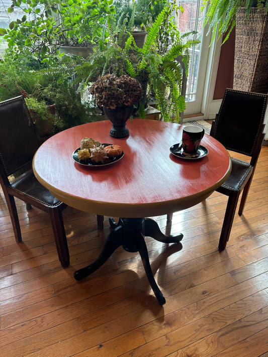 Small Round kitchen table, orange top, yellow beveled area and black legs from above
