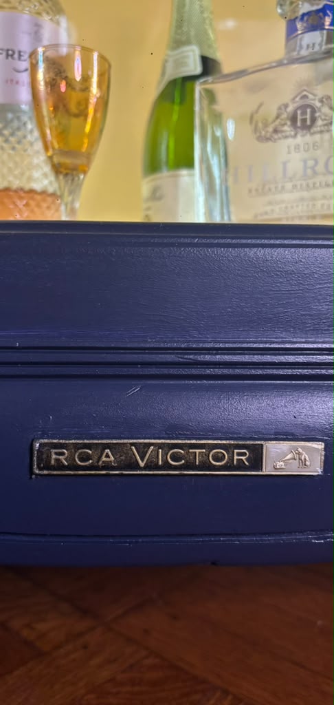 Vintage Victrola transformed into a striking liquor cabinet with Navy Blue and Carnaby Yellow finishes, glass shelves, and remote-controlled lighting