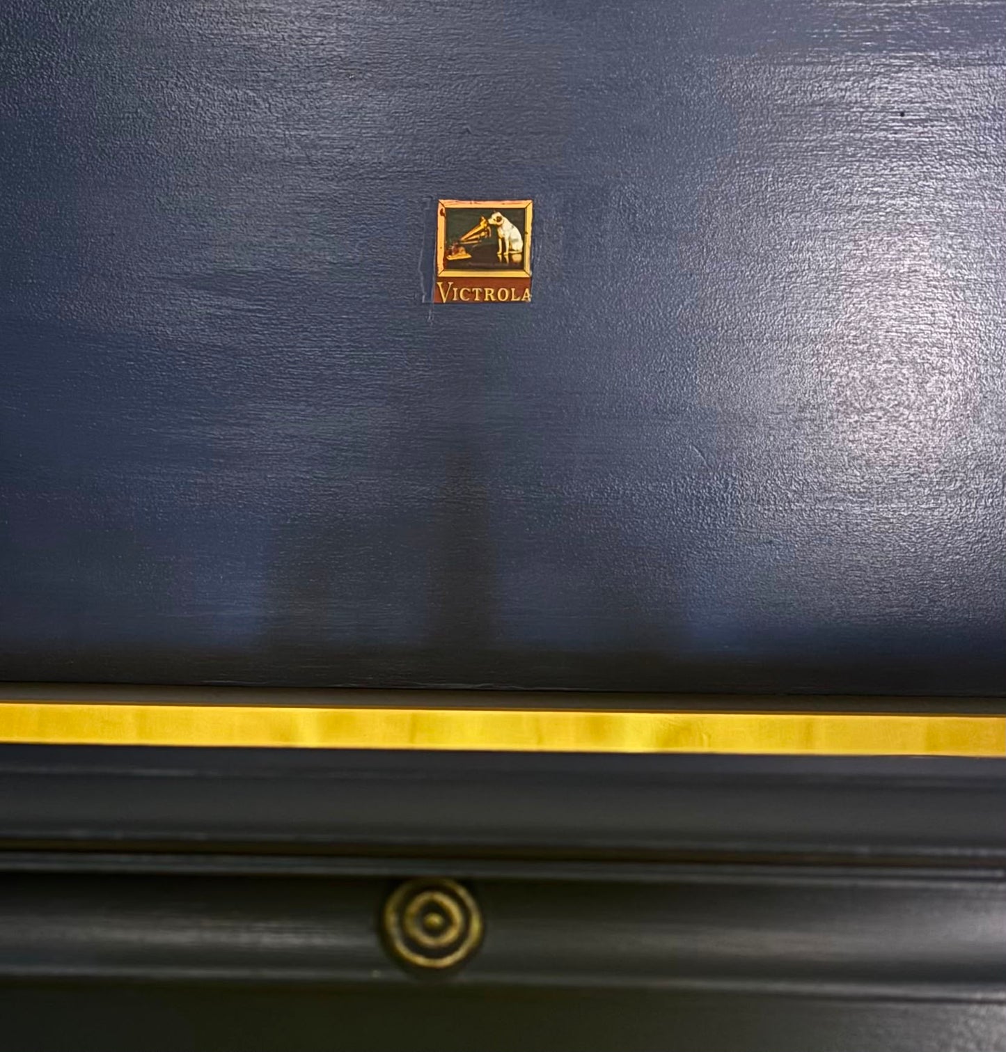 Vintage Victrola transformed into a striking liquor cabinet with Navy Blue and Carnaby Yellow finishes, glass shelves, and remote-controlled lighting