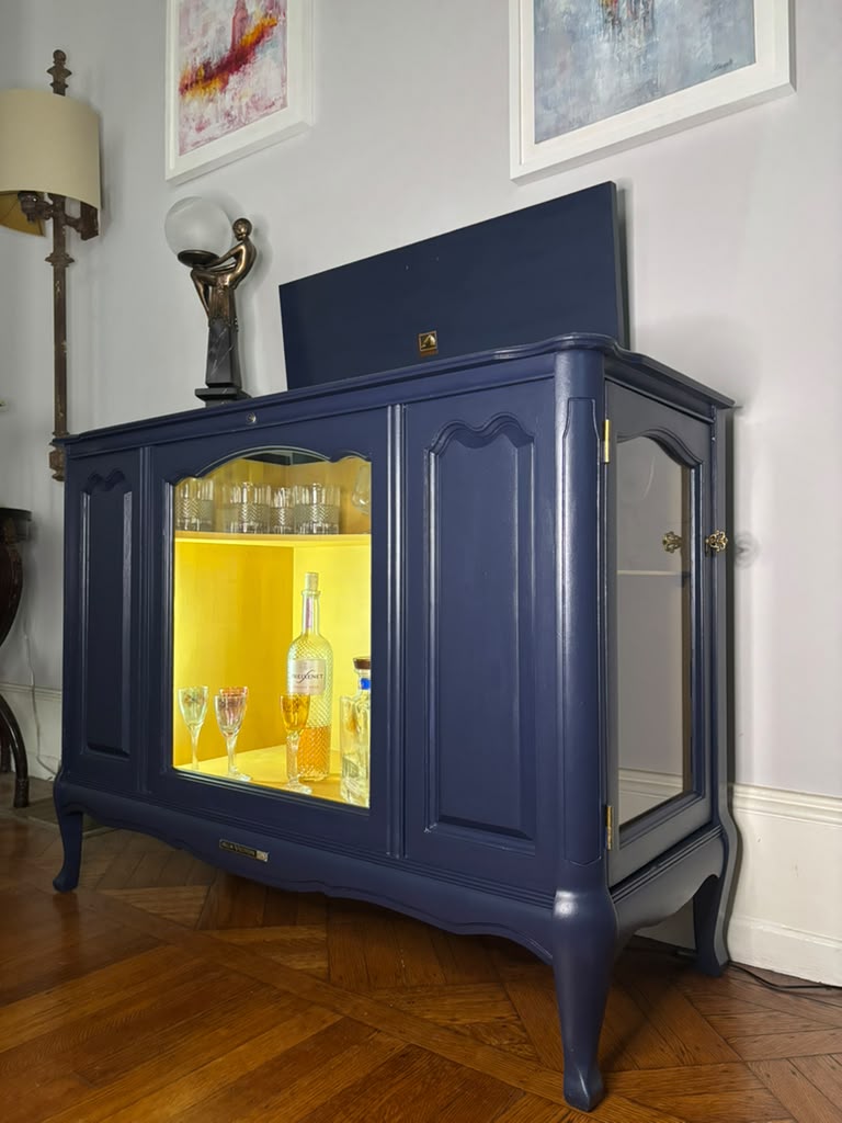 Vintage Victrola transformed into a striking liquor cabinet with Navy Blue and Carnaby Yellow finishes, glass shelves, and remote-controlled lighting