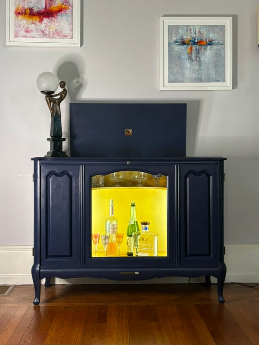 Vintage Victrola transformed into a striking liquor cabinet with Navy Blue and Carnaby Yellow finishes, glass shelves, and remote-controlled lighting