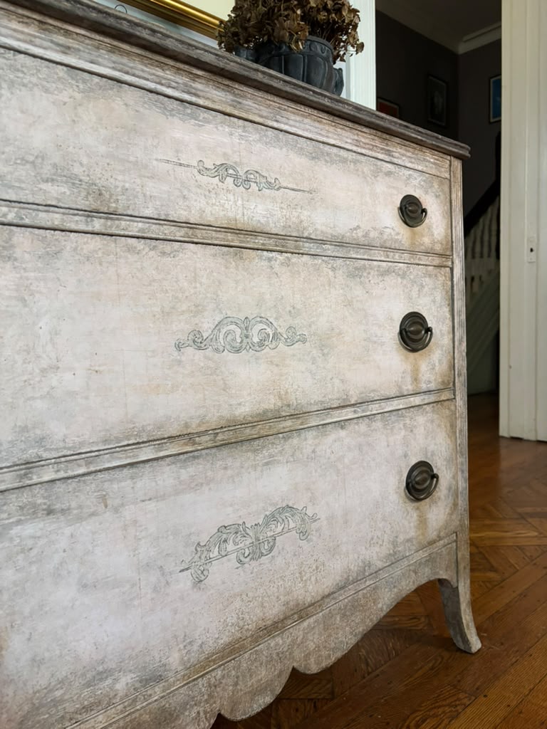 Vintage chest of drawers,  hand-finished limestone patina, subtle ornamental details, and rich bronze hardware for understated European elegance