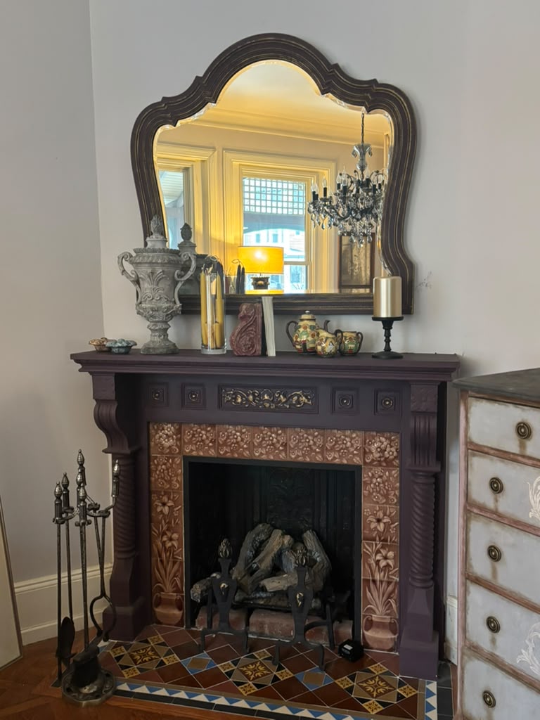 A one-of-a-kind Victorian mantel mirror featuring an original mirror, rich aubergine finish with bronze undertones, and timeless English manor elegance