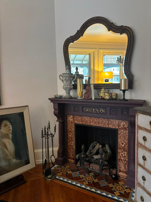 A one-of-a-kind Victorian mantel mirror featuring an original mirror, rich aubergine finish with bronze undertones, and timeless English manor elegance