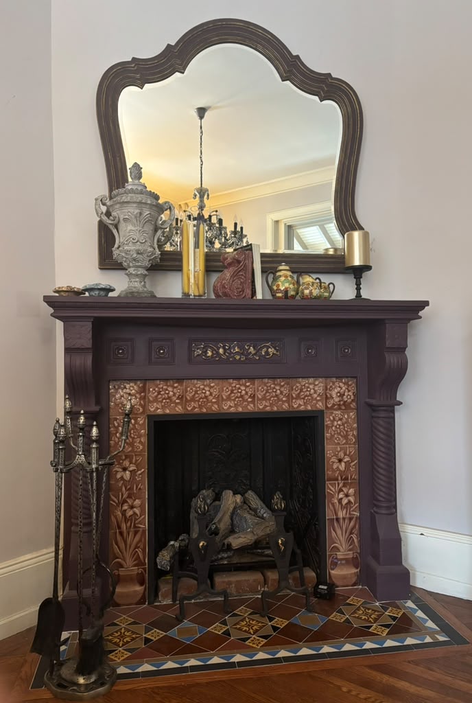 A one-of-a-kind Victorian mantel mirror featuring an original mirror, rich aubergine finish with bronze undertones, and timeless English manor elegance